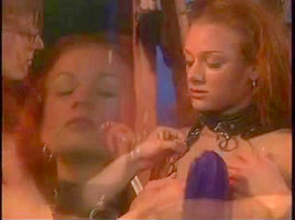 A blonde mistress in latex whipping her slave