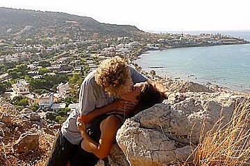 Beautiful teen 18+ Couple In Love Passionately Kissing Above The Sea On Crete Island