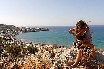 Beautiful teen 18+ Couple In Love Passionately Kissing Above The Sea On Crete Island