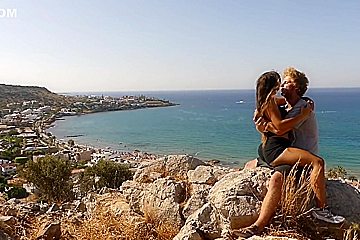 Beautiful teen 18+ Couple In Love Passionately Kissing Above The Sea On Crete Island