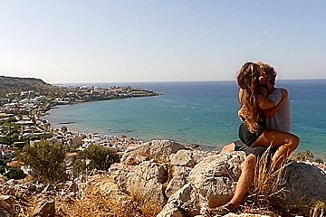 Beautiful teen 18+ Couple In Love Passionately Kissing Above The Sea On Crete Island