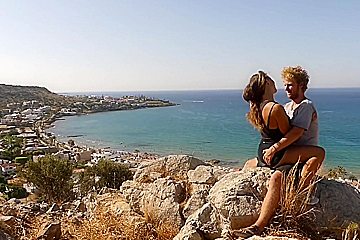 Beautiful teen 18+ Couple In Love Passionately Kissing Above The Sea On Crete Island