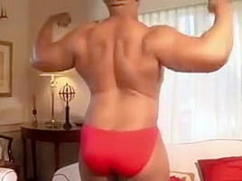 Black beefy guy in a red thong