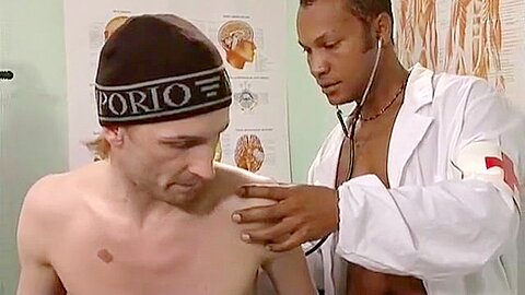 Black doctor examines white gay