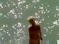 Blonde nude woman in the beach
