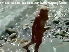 Blonde nude woman in the beach