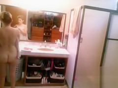 Busty blonde brushes her hair and takes a shower