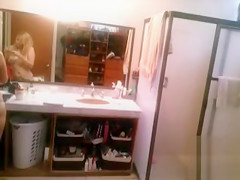 Busty blonde brushes her hair and takes a shower