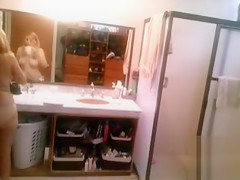 Busty blonde brushes her hair and takes a shower