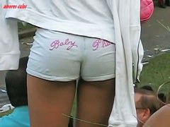 Dark skinned beauty stands in short shorts and a thong ass vid