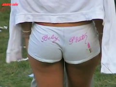Dark skinned beauty stands in short shorts and a thong ass vid