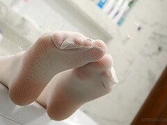 Gentle Feet In White Stockings Plays With Soap Bubbles
