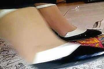 Girl stomping on paper in high heels, black metal high heels crush photo