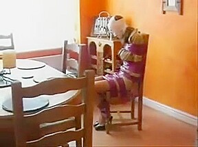 Girl wrapped with tape on the chair