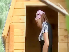 Lady pees in wooden cabin