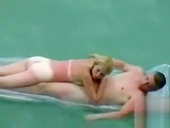 Naked couple floats in the ocean and fucks on the beach