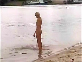 Nude girls outdoor on public beach having fun