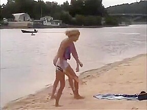 Nude girls outdoor on public beach having fun