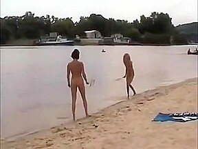 Nude girls outdoor on public beach having fun