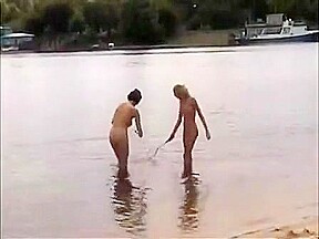 Nude girls outdoor on public beach having fun