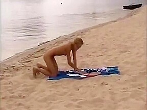 Nude girls outdoor on public beach having fun