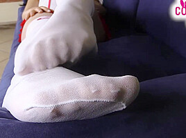 Nurse in white stockings massages her feet and teases you