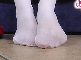 Nurse in white stockings massages her feet and teases you