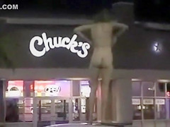 Skinny exhibitionist undresses in a fast food parking lot