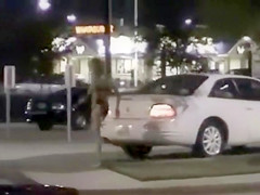 Skinny exhibitionist undresses in a fast food parking lot