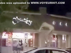 Skinny exhibitionist undresses in a fast food parking lot