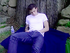 Solo twink jerks off before having a taste of jizz outdoors
