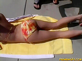 Stripteasing teen hottie catches some rays