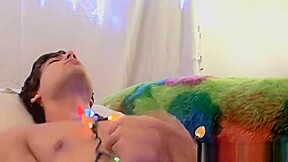 Twink tied with christmas lights wanks his big dick solo