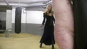 Very hot redhead mistress in leather whipping tied up slave