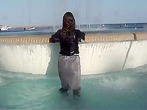 Wetlook fountain: Long black high heel boots, pantyhose, gray skirt