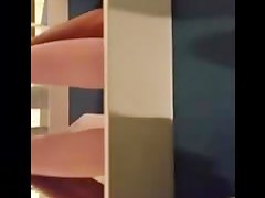 Woman is taking her clothes off in a dressing room