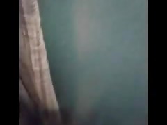 Woman is taking her clothes off in a dressing room