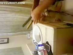 blonde coed throws things at the camera while trying to pee