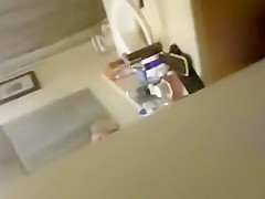 blonde coed throws things at the camera while trying to pee