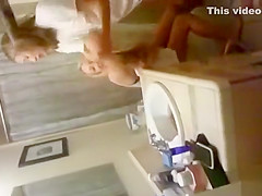 blonde coed throws things at the camera while trying to pee