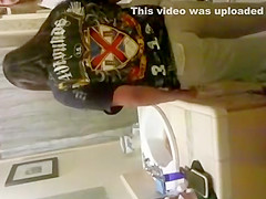 blonde coed throws things at the camera while trying to pee