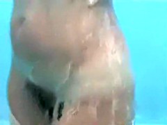 video of couple showering each other in beach cabin